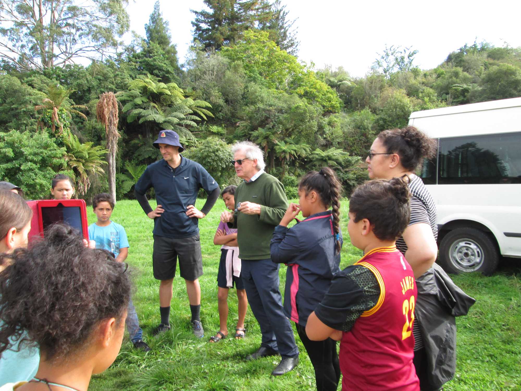 Picture of Paul White teaching children from Te Kōhanga Reo o Tarimano and Te Kura Kaupapa Māori o Te Koutu about the hydrology of the Awahou Stream area. Credit: Heather Martindale.
